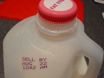 Gallon of milk close-up, with printed expiration Aug 22 1042 AM